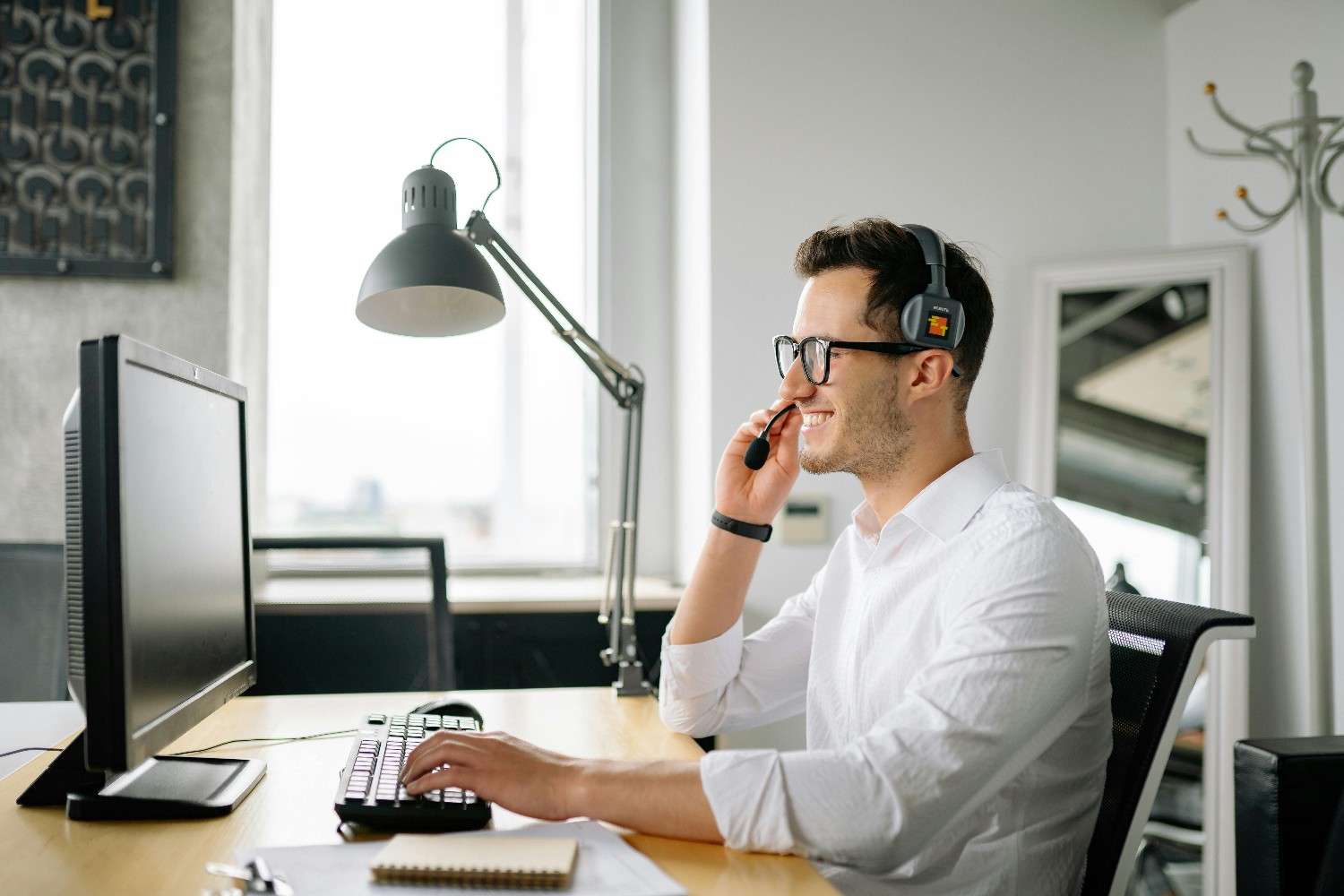A Man wearing a headset in front of his computer screen